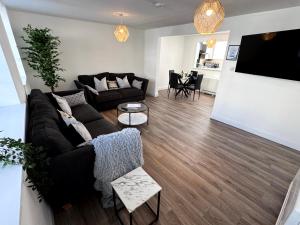 a living room with a couch and a tv at Central 3BR home with Parking in Aberdeen