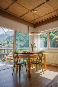 a dining room with a wooden table and chairs at Kreuzwegerhof Nals - Historic Nature Stay with Pool near Meran & Bozen in Nalles