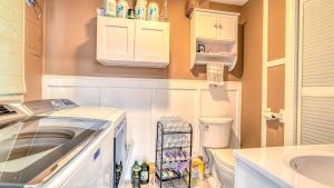 a small bathroom with a toilet and a sink at Shore Escape Steps to the Beach in Ventnor City +10 photos