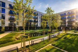 an apartment building with benches in front of a building at Apart Studio Śródmieście in Gdańsk +16 photos