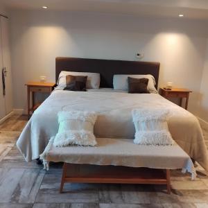 a large bed with a white comforter and pillows at VICTORIA 3 BED AND BREAKFAST A 3KM DEL AEROPUERTO EZEIZa in Ezeiza +20 photos