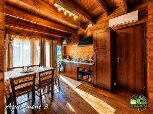 a kitchen with a table and chairs in a cabin at Agriturismo Polgara in Lari