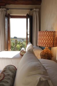 a bedroom with a bed and a large window at Posada San Miguel Arcángel Experience in Arévalo