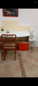 a table and a chair in a room at Casa Leone in Sciacca +6 photos