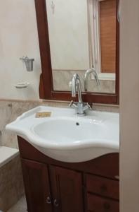 a bathroom with a white sink and a mirror at Casa Leone in Sciacca
