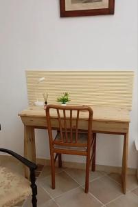 a wooden desk with a chair and a plant on it at Casa Leone in Sciacca