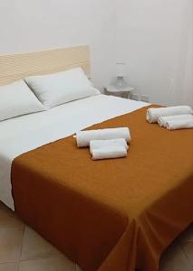 a large bed with two white towels on it at Casa Leone in Sciacca