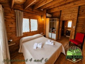 a bedroom with a bed in a log cabin at Agriturismo Polgara in Lari
