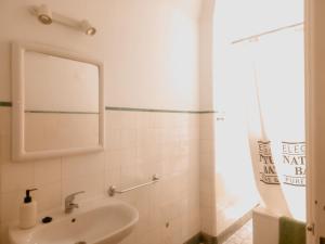 a bathroom with a sink and a mirror at Casa do Mestre By Gt House in Évora +10 photos