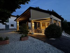 a house with a porch with lights on it at La Torre Granaia in Serravalle Scrivia