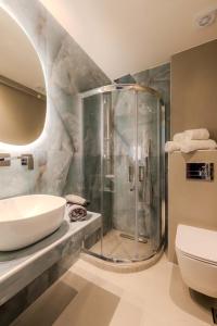 a bathroom with a shower and a sink at Blue Bay Hotel in Skala Potamias