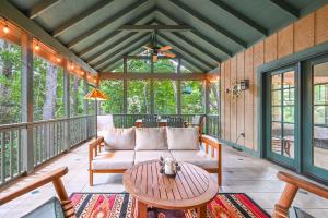 a screened in porch with a couch and a table at The Wander Inn in Black Mountain