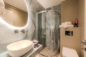 a bathroom with a shower and a toilet and a sink at Blue Bay Hotel in Skala Potamias