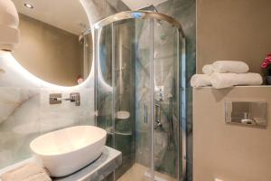 a bathroom with a shower with a toilet and a sink at Blue Bay Hotel in Skala Potamias