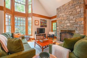 a living room with couches and a stone fireplace at The Wander Inn in Black Mountain
