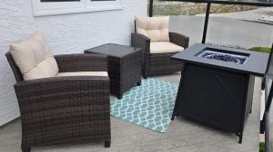 a patio with two chairs and a table and a grill at Lake View Escape! in West Kelowna