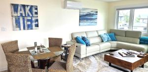 a living room with a couch and a table at Lake View Escape! in West Kelowna +27 photos