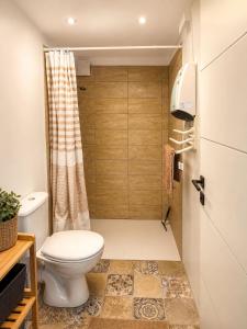 a small bathroom with a toilet and a shower at Studio la garrigue in Les-Pennes-Mirabeau +12 photos