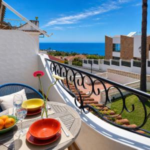 a balcony with a table with plates of food on it at Oceanview Mesa del Mar in Santa Cruz de Tenerife