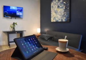 a laptop computer sitting on a table with a cup of coffee at Suite en el corazón de Arandas in Arandas