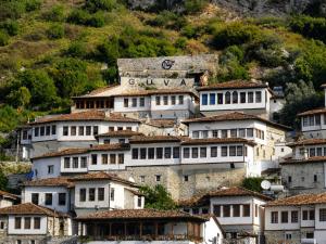 a group of buildings on top of a mountain at Guva Mangalem Boutique Hotel & Restaurant -Berat Old Town View in Berat