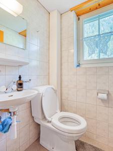 a bathroom with a toilet and a sink at Sonniges Chalet mit fantastischem Bergblick in Lenk +41 photos