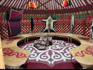 a round bed in a yurt with a star at Юрта in Karakol