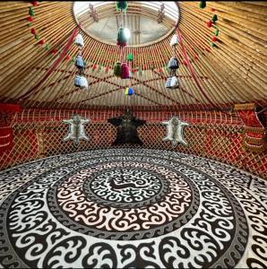 a room with a yurt with a design on the floor at Юрта in Karakol