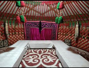 a room with a bed in a yurt at Юрта in Karakol