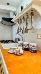 a kitchen counter with plates and utensils on it at Apartment Casa Beatrice in Pizzo +19 photos