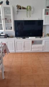 a large white entertainment center with a large flat screen tv at Apartamento MILA centro in Comillas