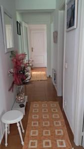 a hallway with a white door and a white table at Apartamento MILA centro in Comillas +9 photos