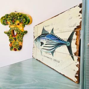 a book with a drawing of a fish on it at Apartment Casa Beatrice in Pizzo