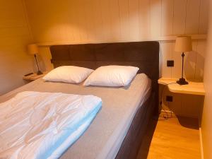 a bed with two pillows on it in a room at Natuur, Rust & Ontspanning in de Ardennen in Rendeux