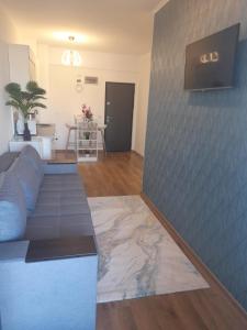 a living room with a couch and a table at Apartament Camelia in Saturn