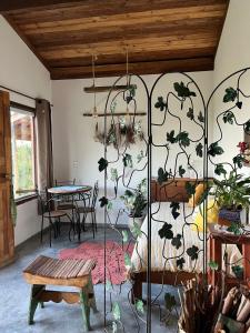 a room with a bed with plants on the wall at Casa Aroni - 1300m altitude in Extrema