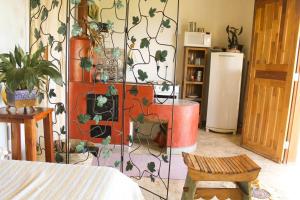 a room with a wall with a plant mural at Casa Aroni - 1300m altitude in Extrema