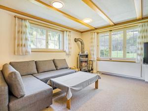a living room with a couch and a table at Sonniges Chalet mit fantastischem Bergblick in Lenk