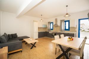 a living room with a couch and a table at Blue Veranda Apartment in Pera Gyalos
