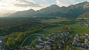 an aerial view of a town in a valley with mountains at Glamping by the Old Mill in Preddvor