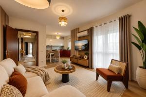 a living room with a couch and a table at Big Center Beachfront Apartment in Durrës