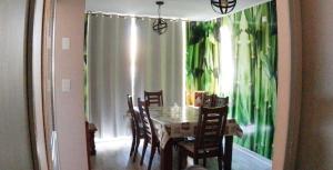 a dining room with a table and chairs and a window at Departamento Los Andes in Los Andes