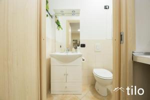 a bathroom with a toilet and a sink at City center 4’|Studio|wifi|By tilo in Genoa
