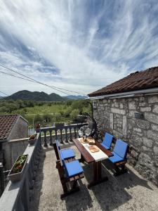 a table and chairs on a balcony with a view at Lake Escape Dodoši in Dodoši