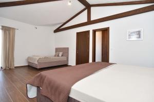 a bedroom with a bed and a couch at Vila sa bazenom Emar, Budva in Krimovice +44 photos
