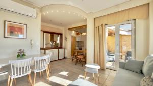 a kitchen and living room with a table and chairs at Lumaverde Estate in Kalamata