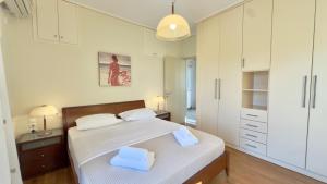 a bedroom with a bed with two towels on it at Lumaverde Estate in Kalamata