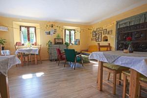 a room with two tables and chairs and a living room at Glamping by the Old Mill in Preddvor