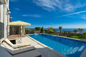 a swimming pool with a view of the ocean at Vila sa bazenom Emar, Budva in Krimovice