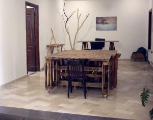 a wooden table and chairs in a room at Atelier Meso in Le Kram